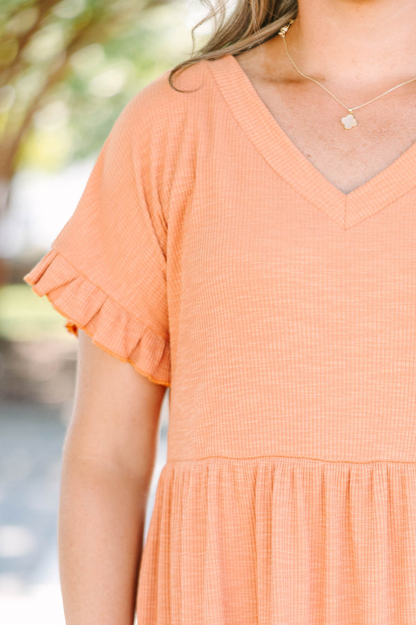 Plus size marmalade orange dress with a flowy babydoll fit, V-neckline, and ruffle sleeve details.