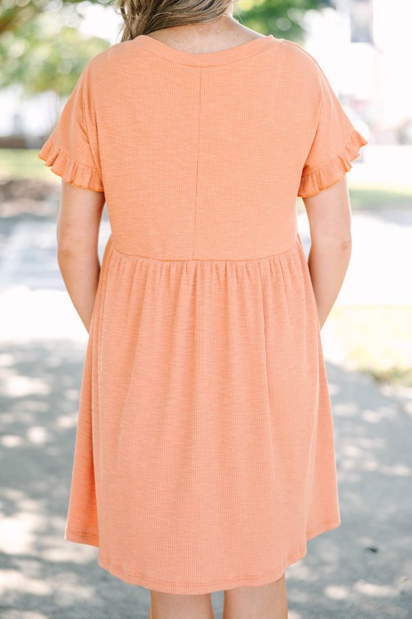Plus size marmalade orange dress with a flowy babydoll fit, V-neckline, and ruffle sleeve details.