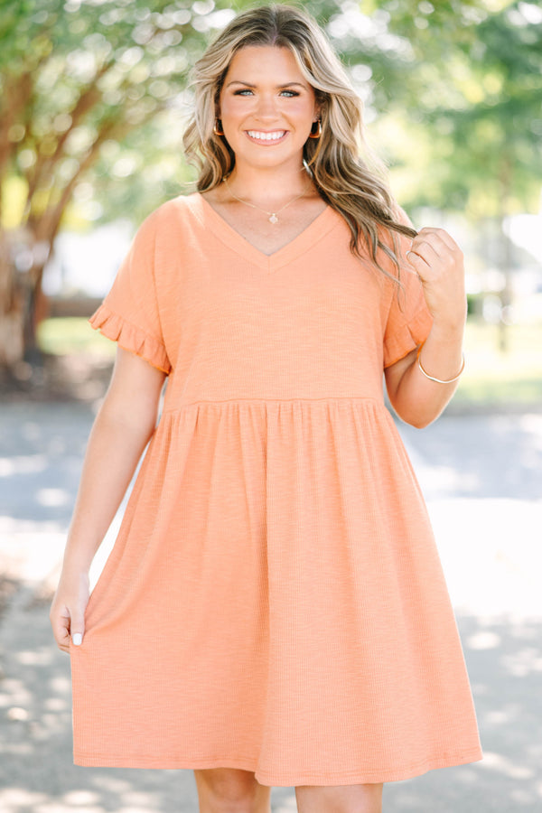 Plus size marmalade orange dress with a flowy babydoll fit, V-neckline, and ruffle sleeve details.