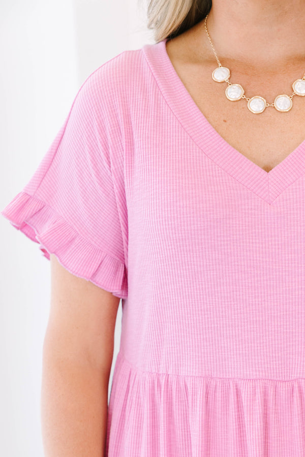 Plus Size pink textured v-neck dress with short ruffle sleeves and a tiered skirt.