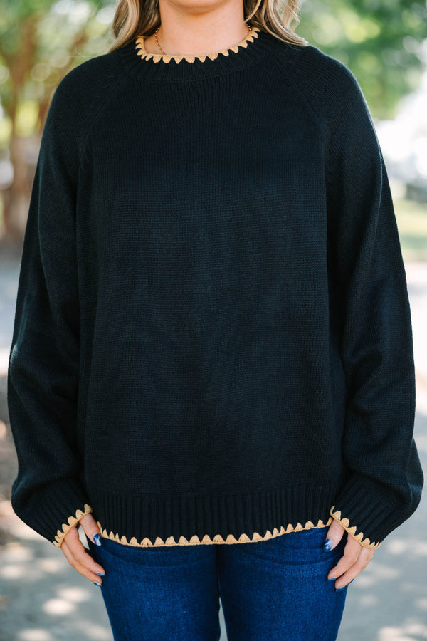 Plus size black knit sweater with tan scalloped trim on the crew neck, cuffs, and hem.