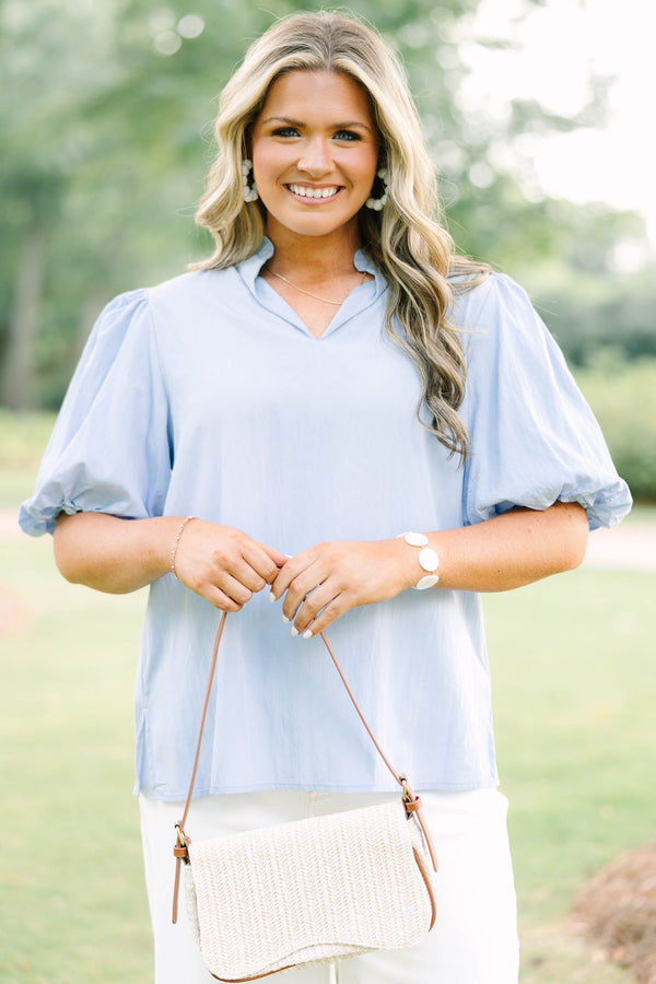 Plus Size light blue top with puff sleeves, a v-neckline, and a relaxed fit.