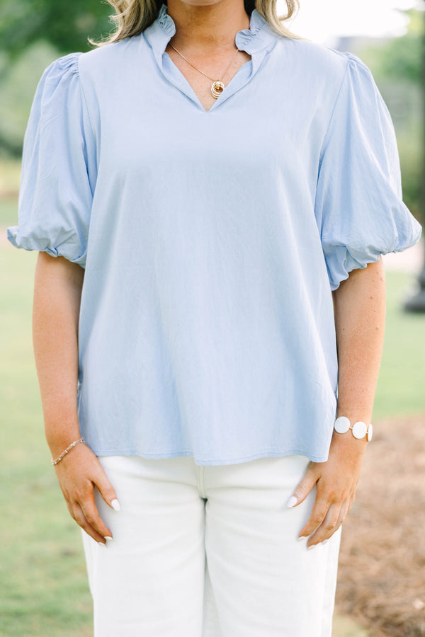 Plus Size light blue top with puff sleeves, a v-neckline, and a relaxed fit.