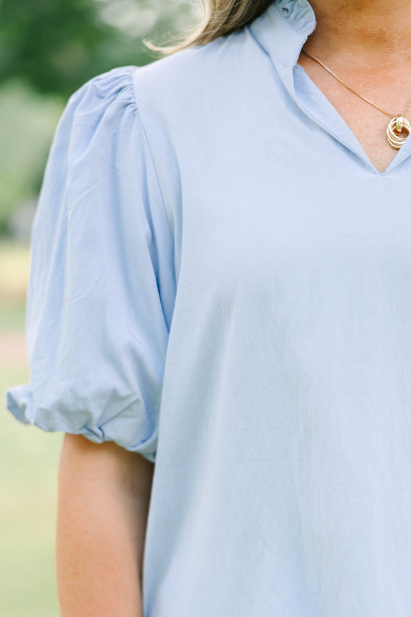 Plus Size light blue top with puff sleeves, a v-neckline, and a relaxed fit.