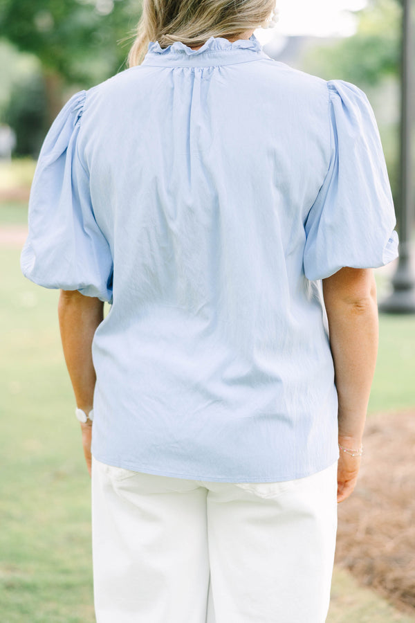 Plus Size light blue top with puff sleeves, a v-neckline, and a relaxed fit.