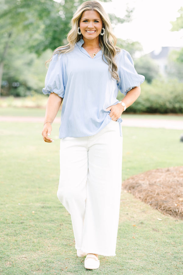 Plus Size light blue top with puff sleeves, a v-neckline, and a relaxed fit.
