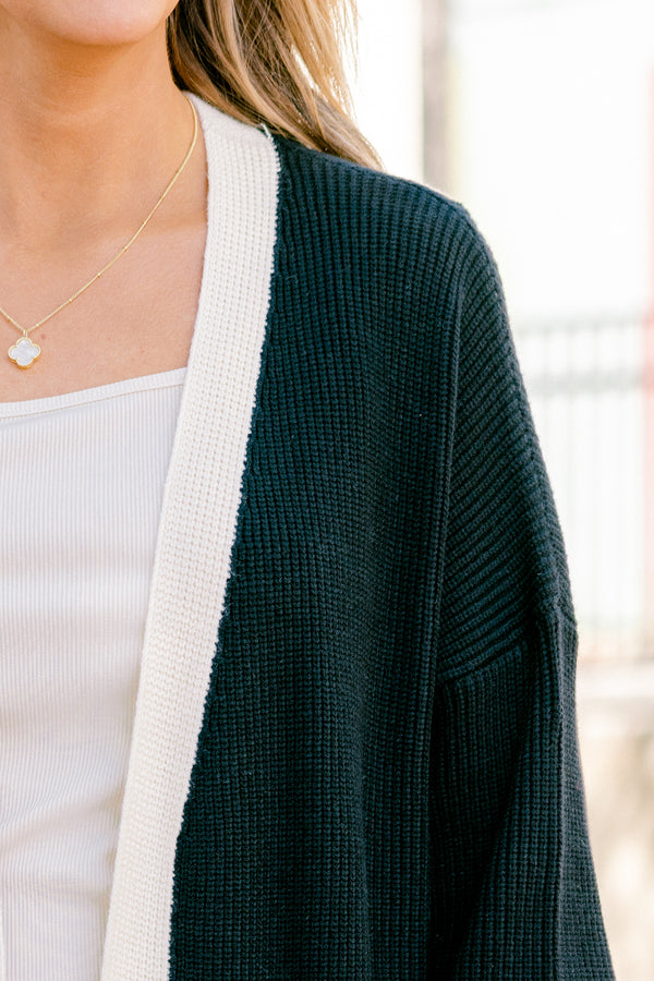 Chic Soul plus size clothing, black long sleeve cardigan with a white striped going down the center of the cardigan and around the end of the sleeves 