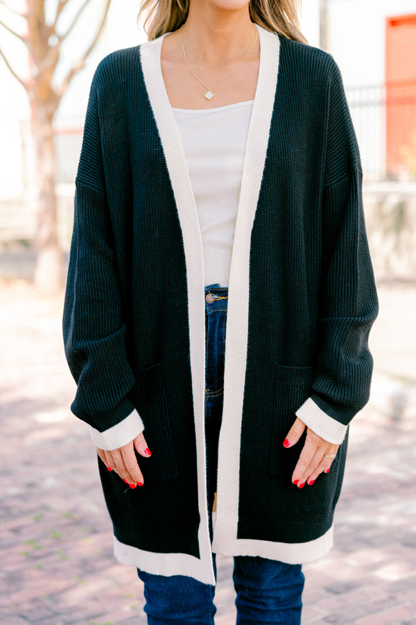 Chic Soul plus size clothing, black long sleeve cardigan with a white striped going down the center of the cardigan and around the end of the sleeves 