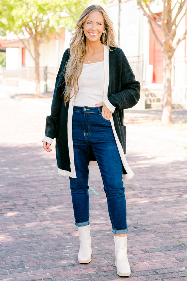 Chic Soul plus size clothing, black long sleeve cardigan with a white striped going down the center of the cardigan and around the end of the sleeves 