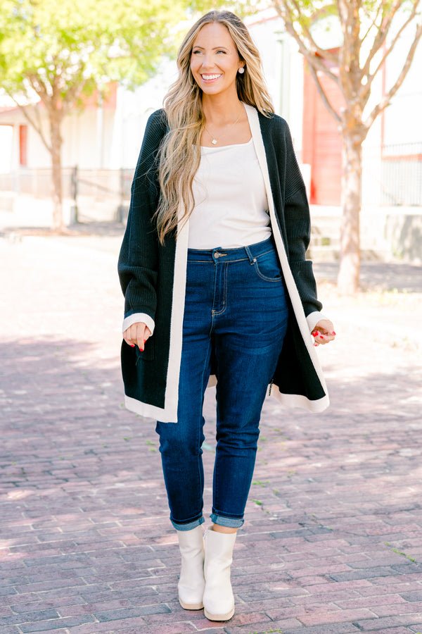 Chic Soul plus size clothing, black long sleeve cardigan with a white striped going down the center of the cardigan and around the end of the sleeves 