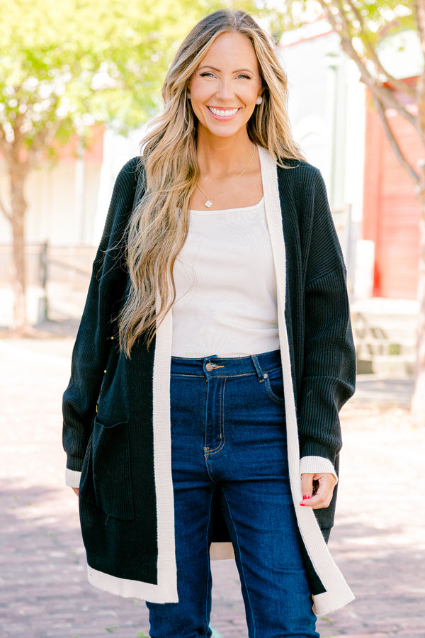 Chic Soul plus size clothing, black long sleeve cardigan with a white striped going down the center of the cardigan and around the end of the sleeves 
