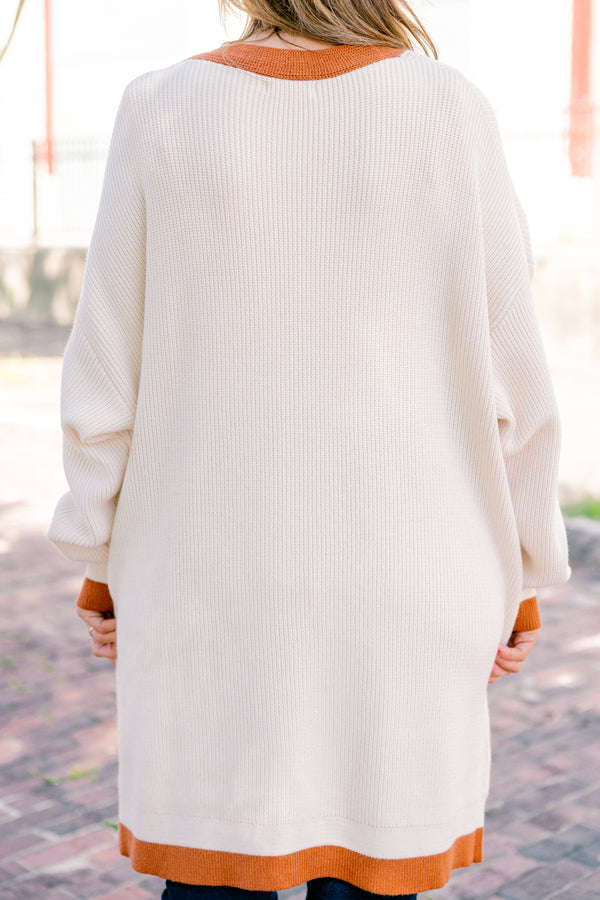 Chic Soul Plus size Clothing, cream long sleeve cardigan with a camel colored stripe going down the insides of the cardigan at the end of each sleeve and along the bottom 

