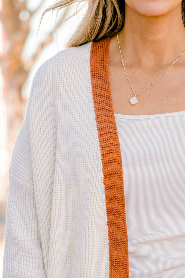 Chic Soul Plus size Clothing, cream long sleeve cardigan with a camel colored stripe going down the insides of the cardigan at the end of each sleeve and along the bottom 
