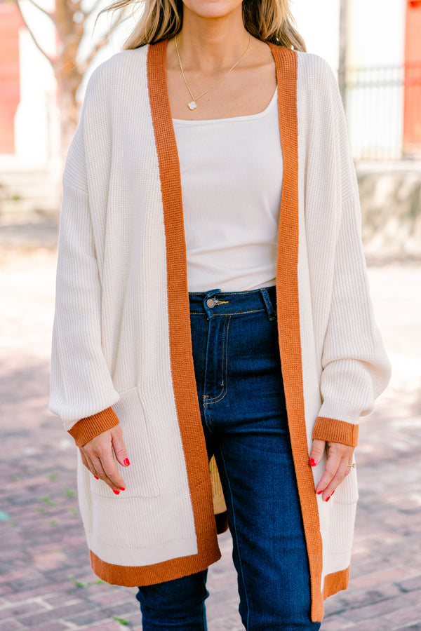 Chic Soul Plus size Clothing, cream long sleeve cardigan with a camel colored stripe going down the insides of the cardigan at the end of each sleeve and along the bottom 
