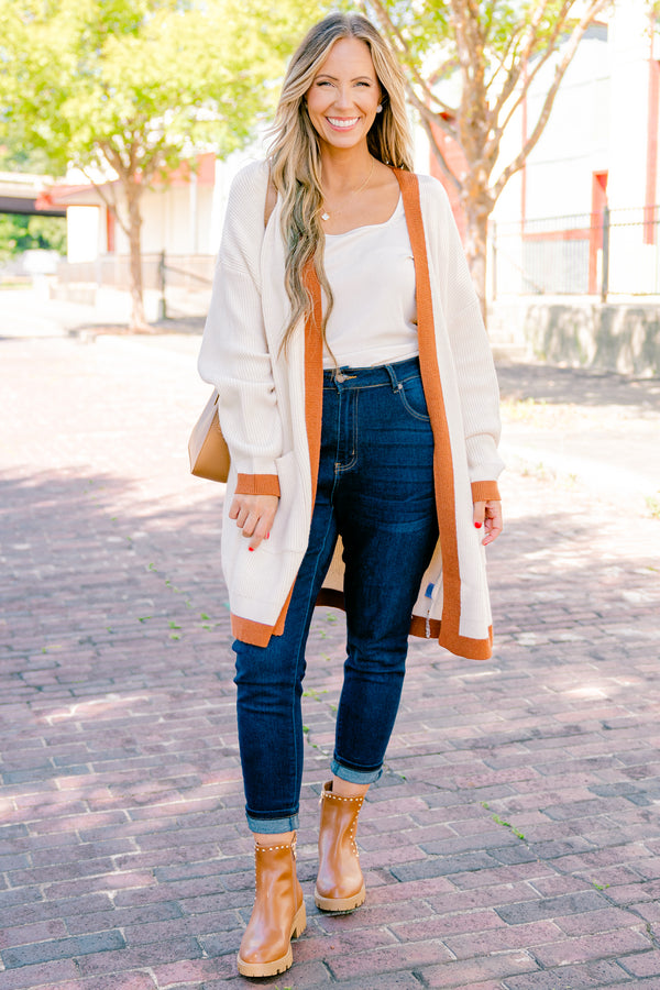 Chic Soul Plus size Clothing, cream long sleeve cardigan with a camel colored stripe going down the insides of the cardigan at the end of each sleeve and along the bottom 
