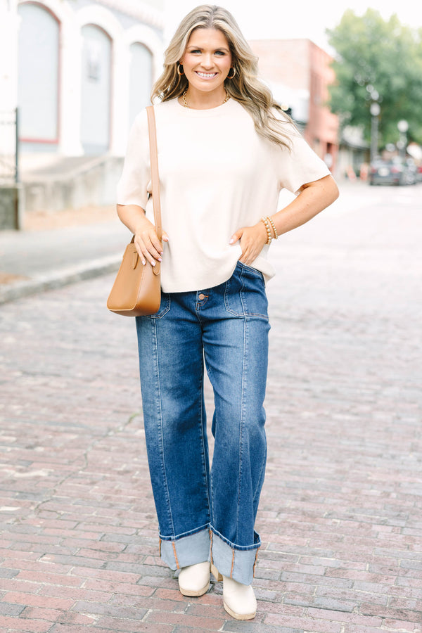 Plus Size dark wash wide leg jeans with a button fly, front seam details, and versatile cuffed hems.