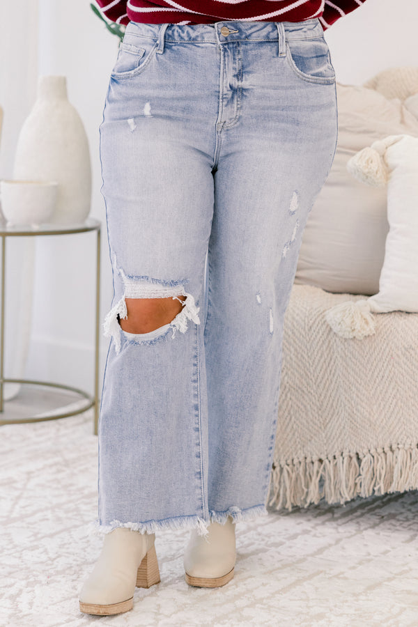 Chic Soul plus size clothing, light wash jeans with distressed details throughout and a hole in the right knee as well as two front pockets