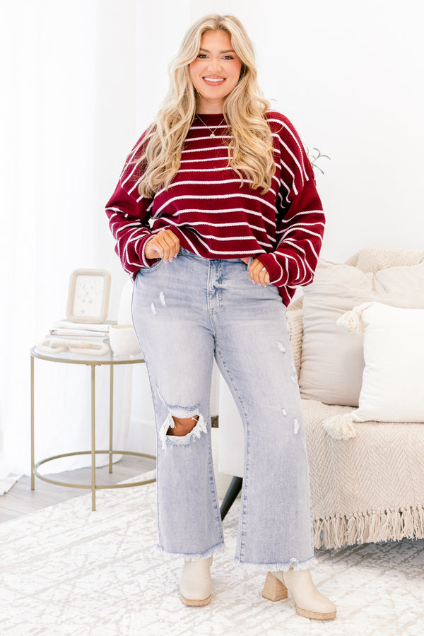 Chic Soul plus size clothing, light wash jeans with distressed details throughout and a hole in the right knee as well as two front pockets