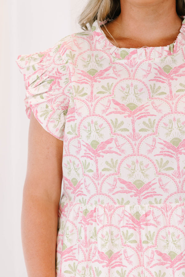 Plus size pink and green floral maxi dress with ruffle sleeves and a flowy tiered silhouette.