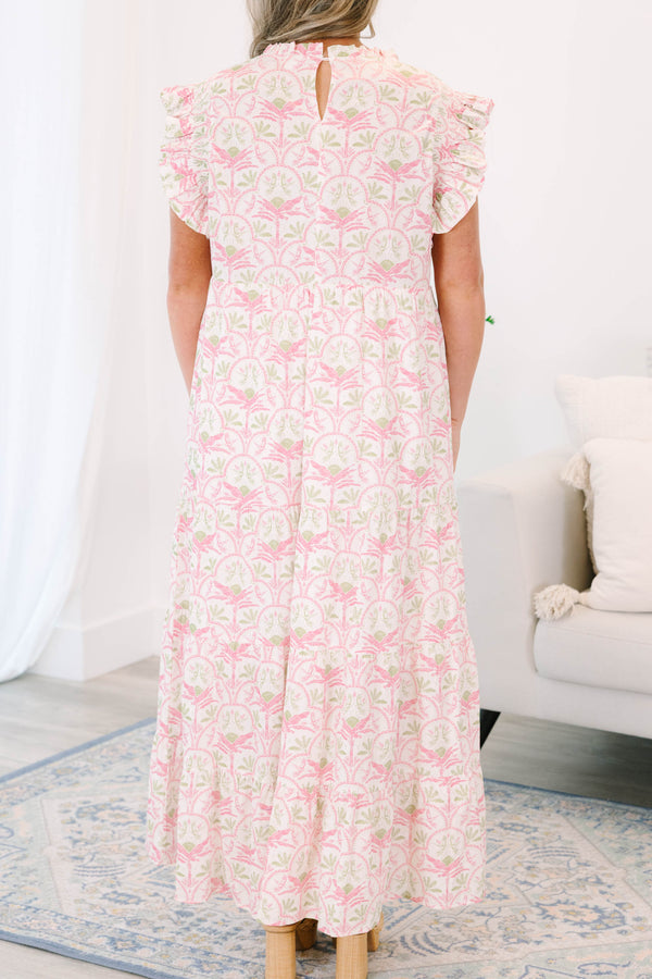 Plus size pink and green floral maxi dress with ruffle sleeves and a flowy tiered silhouette.