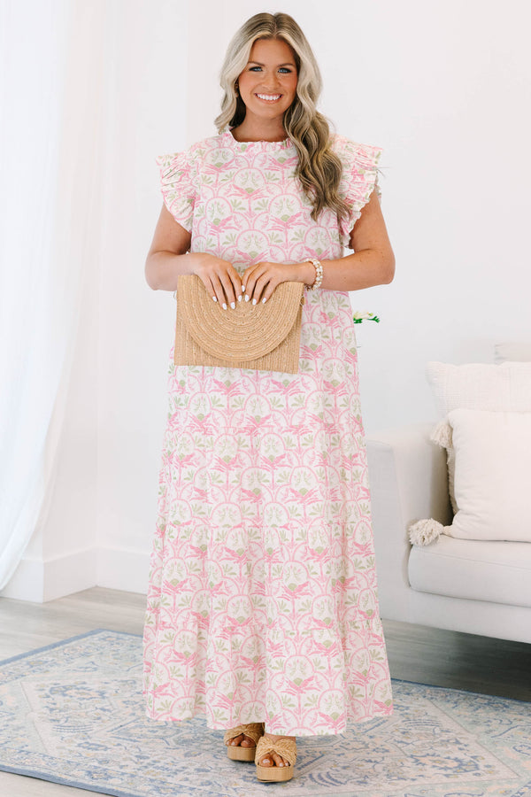Plus size pink and green floral maxi dress with ruffle sleeves and a flowy tiered silhouette.