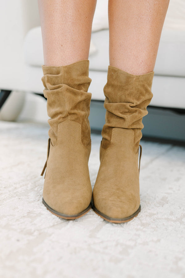 Tan suede-like booties with a slouchy shaft, fringe detail, and stacked block heel.