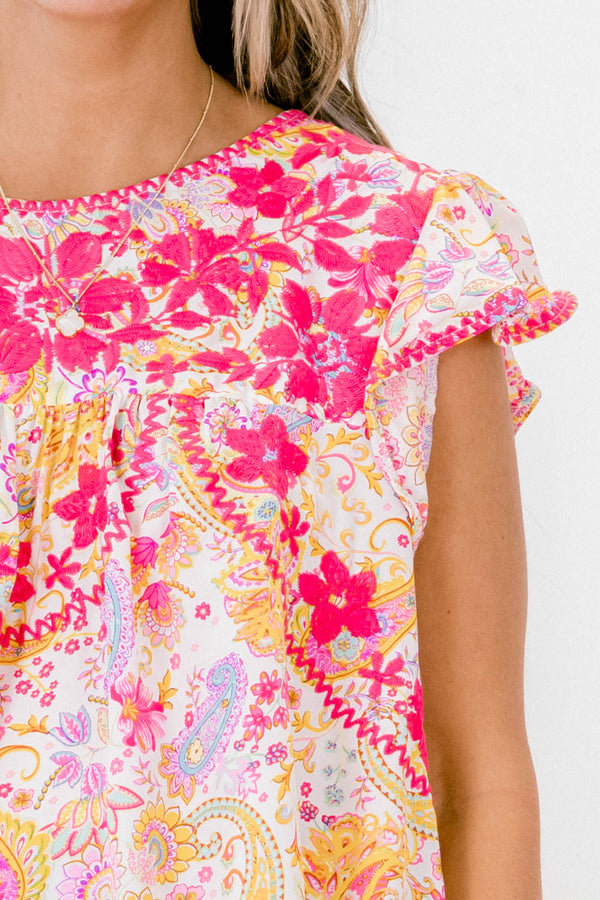 Chic Soul plus size clothing, orange and pink paisley print short flutter sleeve top with pink embroidered details on the chest.