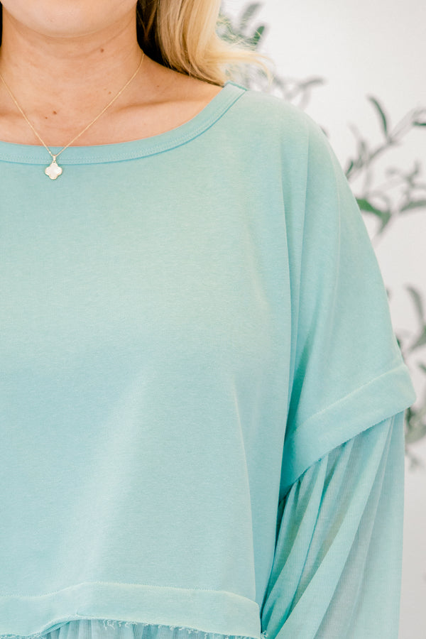 Chic Soul plus size clothing, seafoam blue long sleeve top with round neckline and cuff sleeves with tiered ruffle detail along the bottom