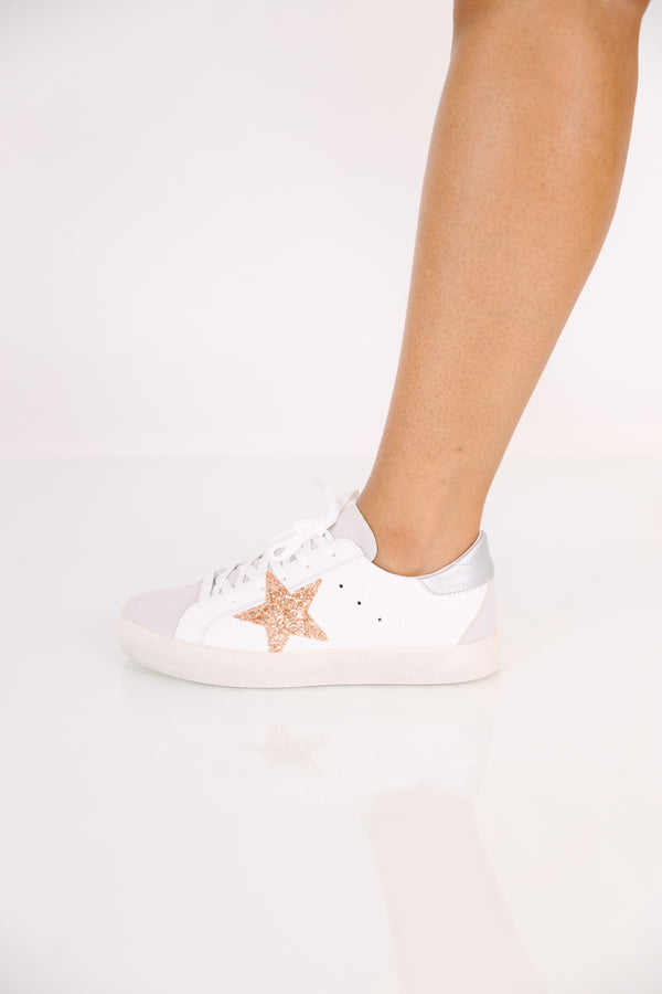 White low-top lace-up sneakers with a silver metallic base and a gold glitter star accent.