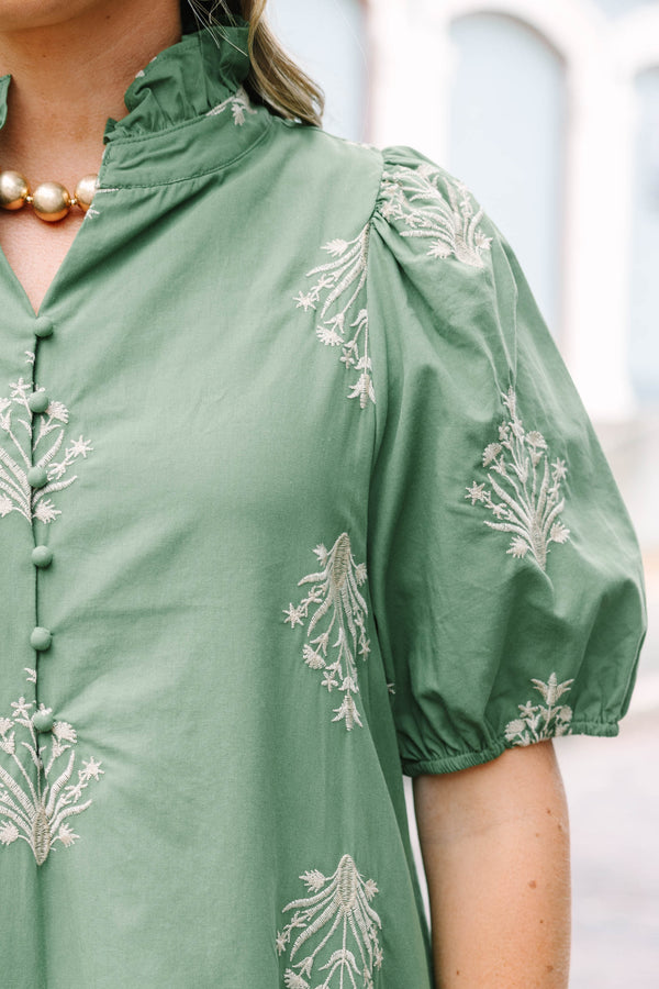 Plus Size olive green midi dress with cream botanical embroidery, puff sleeves, and a ruffled hem.