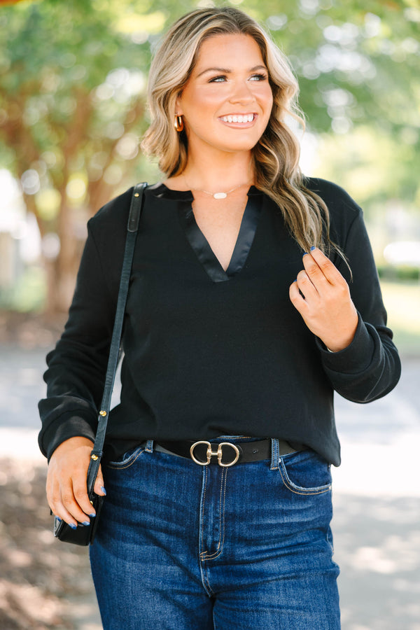 Plus size black long sleeve top with a satin V-neckline and ribbed cotton fabric.