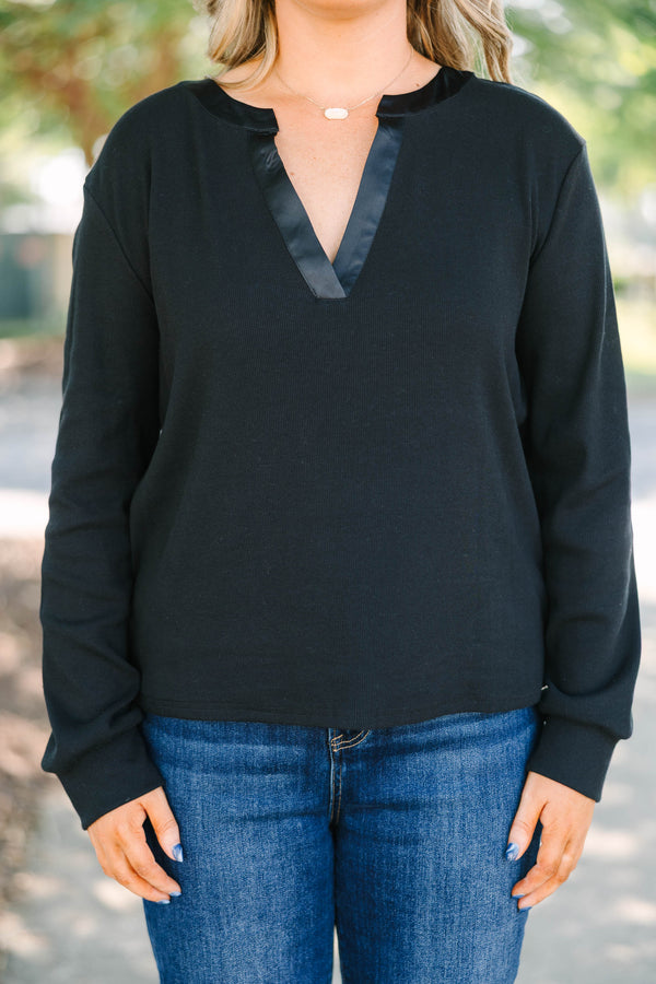 Plus size black long sleeve top with a satin V-neckline and ribbed cotton fabric.