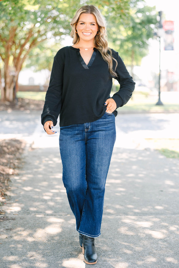 Plus size black long sleeve top with a satin V-neckline and ribbed cotton fabric.