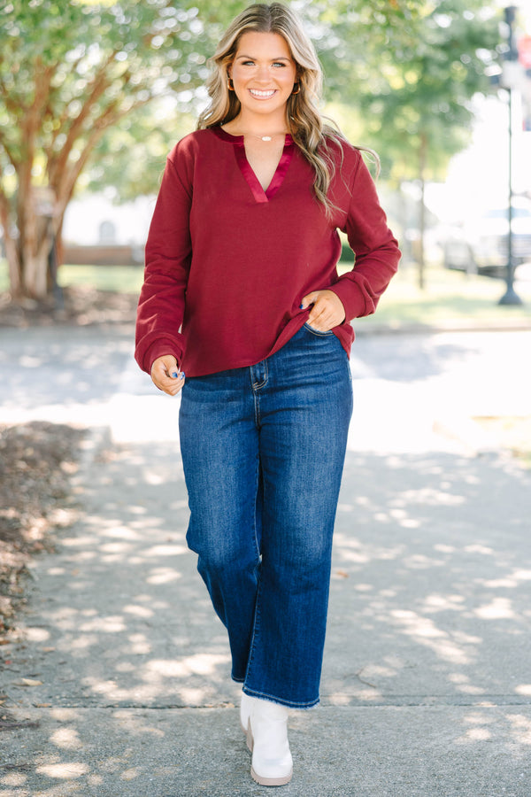 Plus Size burgundy long sleeve top with a ribbed texture and a satin-trimmed v-neckline.