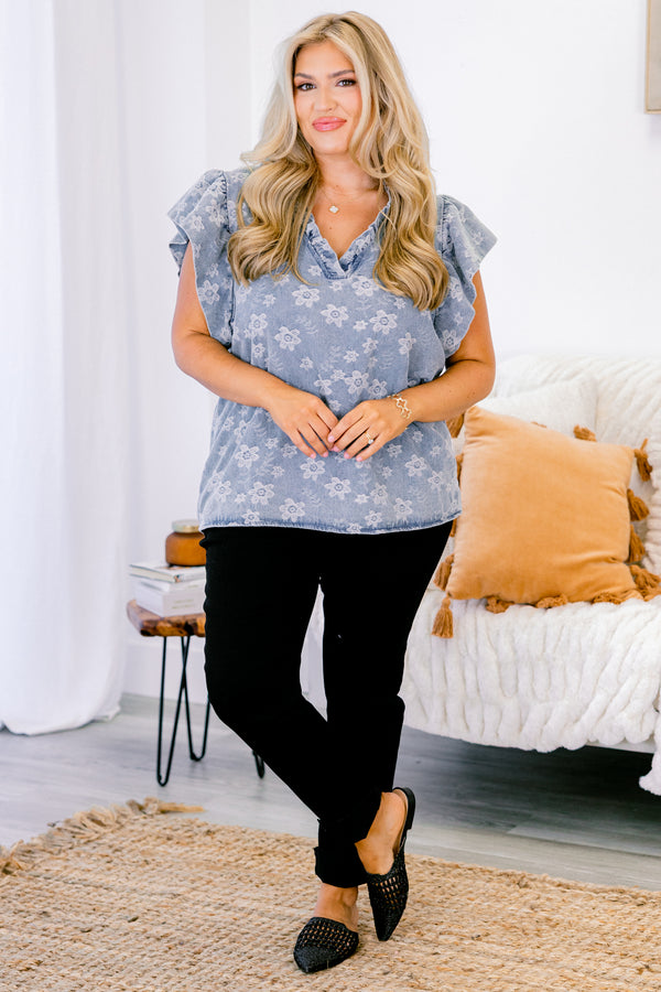 Chic Soul plus size clothing, short-flutter-sleeve denim blue top with a ruffled v-neckline and a subtle lighter wash floral pattern