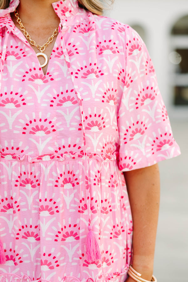 Plus Size fuchsia and light pink patterned tiered mini dress with short sleeves and tassel ties.