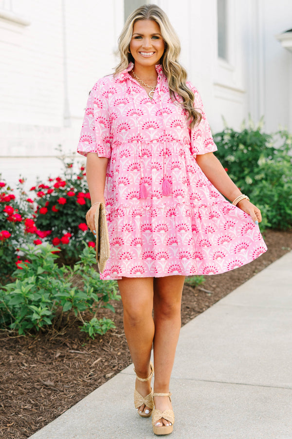 Plus Size fuchsia and light pink patterned tiered mini dress with short sleeves and tassel ties.