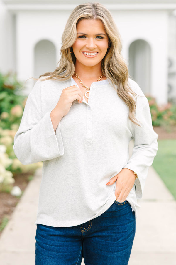 Heather grey oversized knit henley top with a button placket and dropped shoulders.