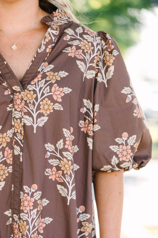Plus Size brown floral mini dress with puff sleeves, a v-neckline, and a tiered skirt.