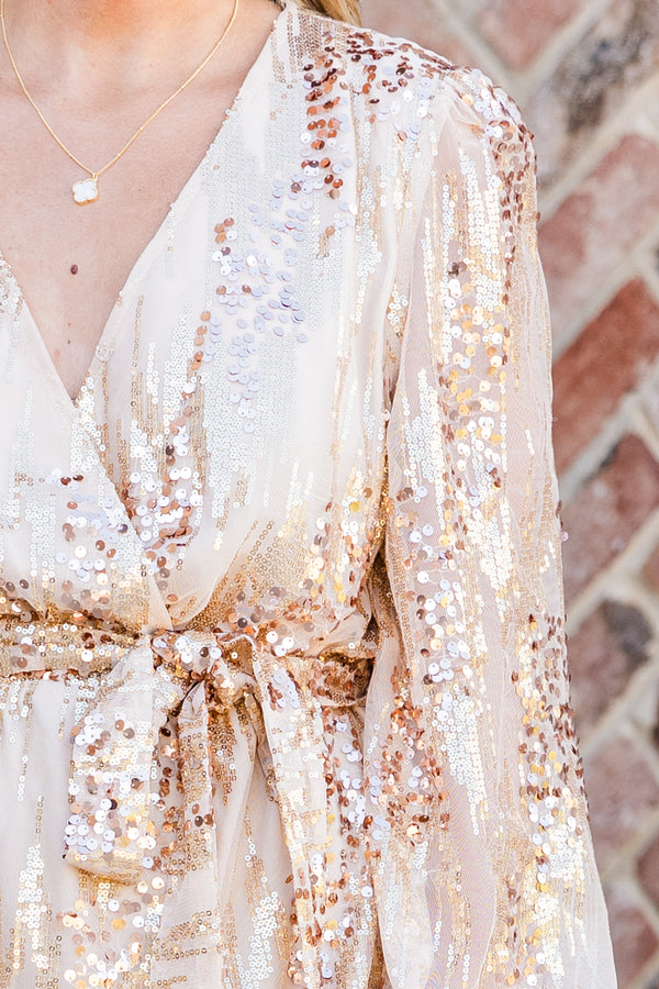 Chic Soul plus size clothing, long-sleeve champagne gold dress with waist-tie and deep v-neckline with sequins scattered across it 