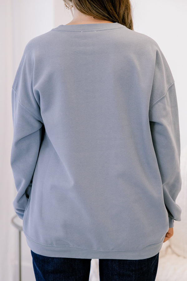 Chic Soul plus size clothing, long-sleeve denim blue crewneck pullover with graphic art displaying three pink multi-colored nutcrackers with pink bows on them 