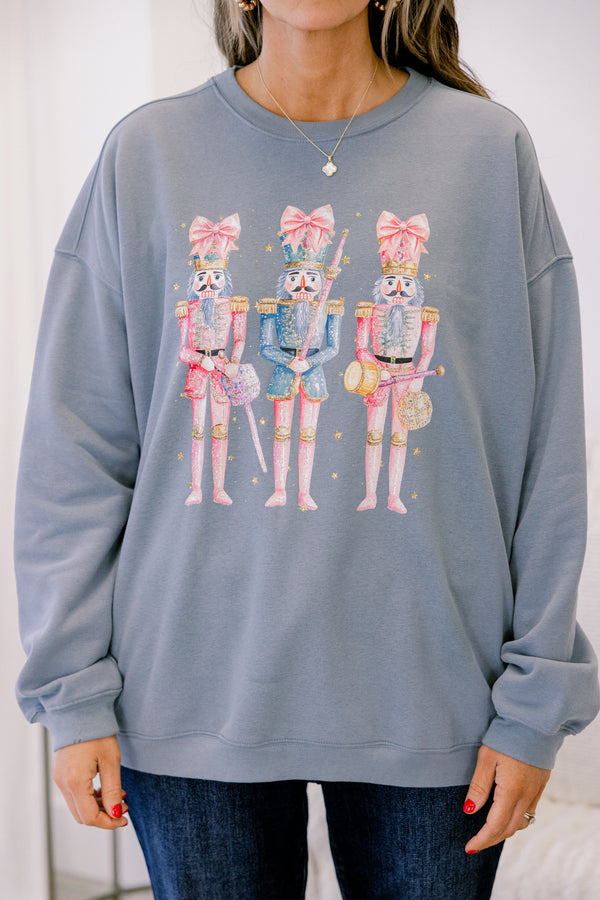 Chic Soul plus size clothing, long-sleeve denim blue crewneck pullover with graphic art displaying three pink multi-colored nutcrackers with pink bows on them 