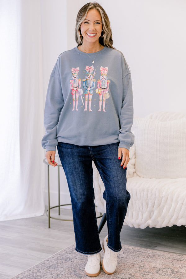 Chic Soul plus size clothing, long-sleeve denim blue crewneck pullover with graphic art displaying three pink multi-colored nutcrackers with pink bows on them 