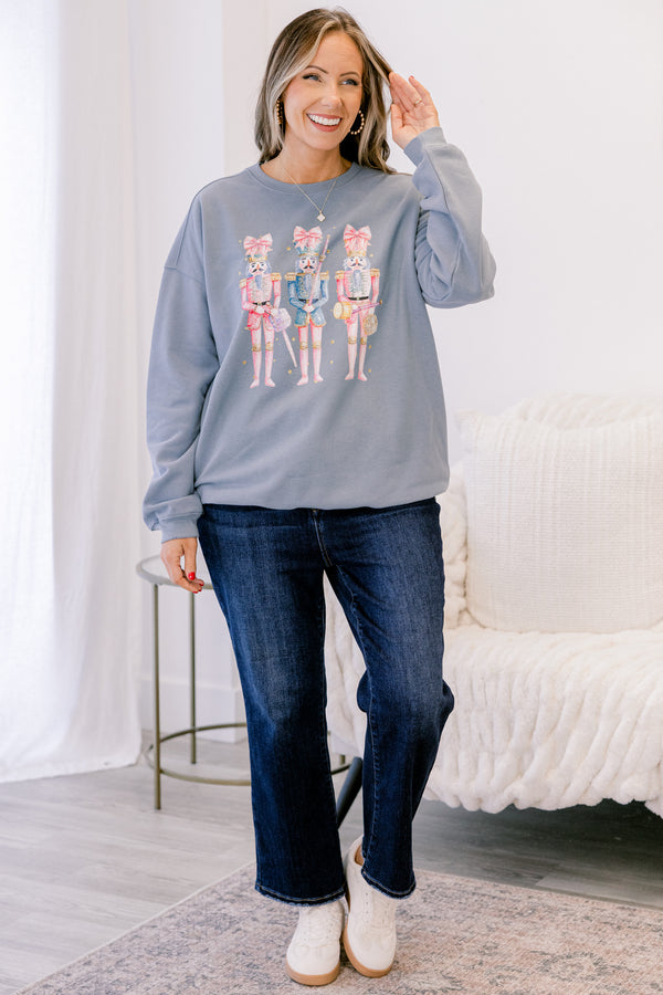 Chic Soul plus size clothing, long-sleeve denim blue crewneck pullover with graphic art displaying three pink multi-colored nutcrackers with pink bows on them 