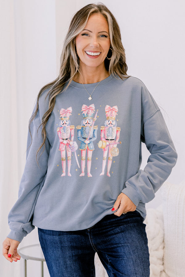 Chic Soul plus size clothing, long-sleeve denim blue crewneck pullover with graphic art displaying three pink multi-colored nutcrackers with pink bows on them 