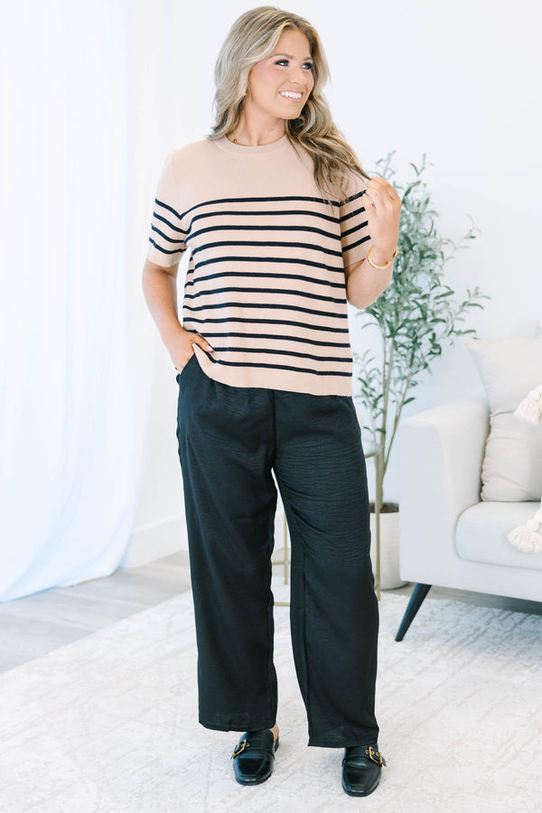 Plus size black wide-leg pants with a comfortable elastic waist and flowy, textured fabric.
