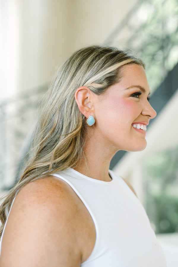Plus Size irregular gold-rimmed stud earrings with smooth, light blue stone centers.