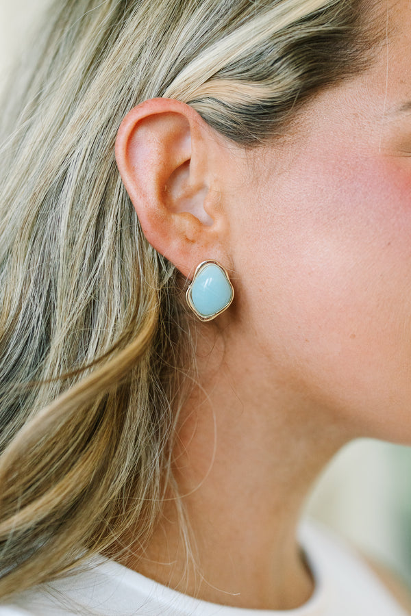 Plus Size irregular gold-rimmed stud earrings with smooth, light blue stone centers.