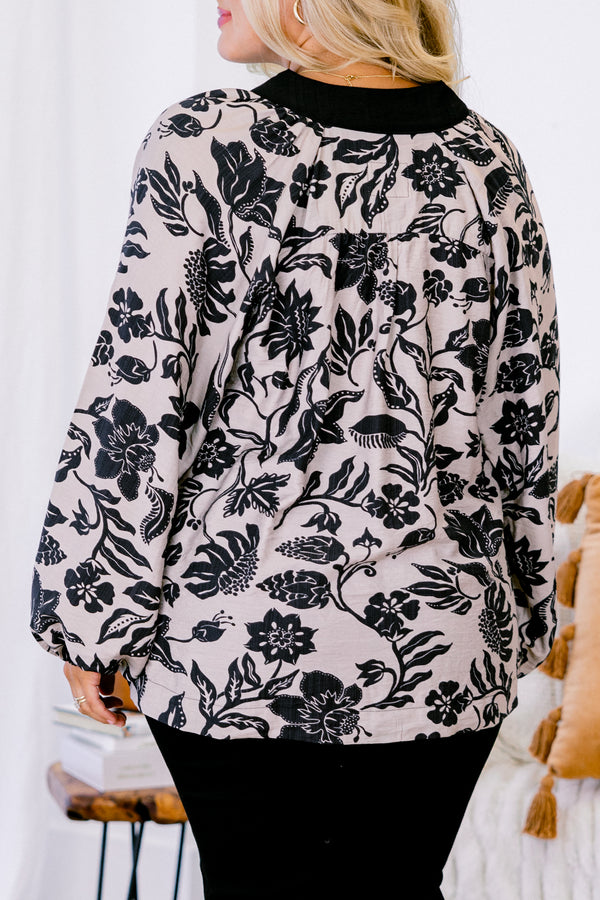 Chic Soul plus size clothing, taupe long sleeve blouse with a black floral pattern and black accents around the v-neckline 
