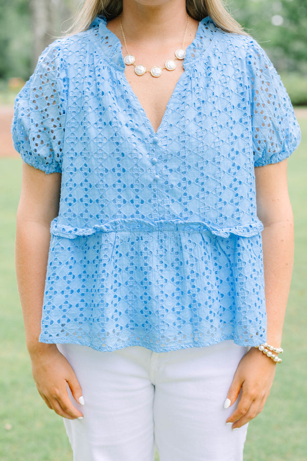 Plus Size blue eyelet babydoll top with short puff sleeves, V-neckline, and button-front detail.